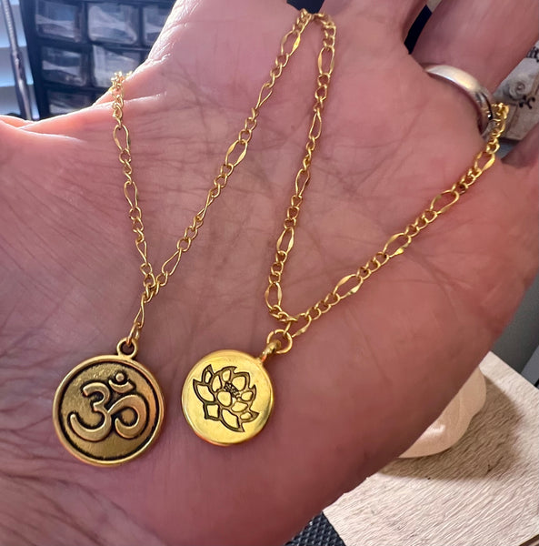 Gold-tone Ohm or Lotus 7.5 bracelet