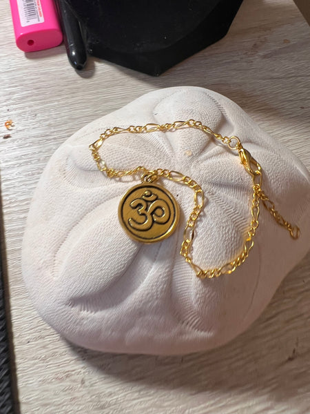Gold-tone Ohm or Lotus 7.5 bracelet