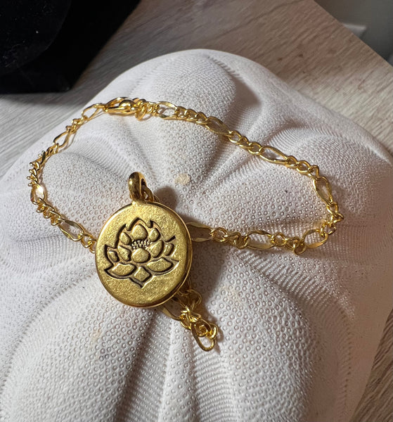 Gold-tone Ohm or Lotus 7.5 bracelet